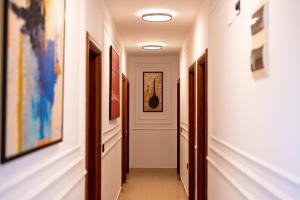 a hallway with paintings and pictures on the walls at Rexha Apartments in Ulcinj