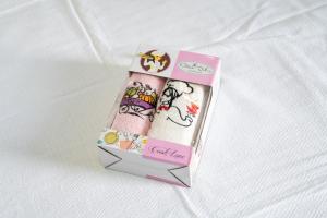 a box of hello kitty cartoons is on a bed at Rexha Apartments in Ulcinj