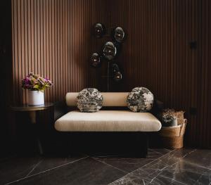 a bench in a room with flowers and plants at Serbellas Boutique Hotel in Paphos +49 photos