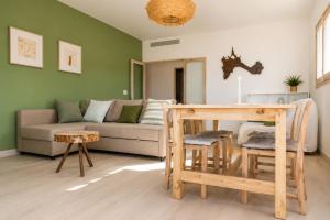 a living room with a couch and a table at Apartamentos Es Cupina in La Mola