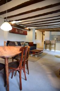a living room with a wooden table and a couch at Casas del río in Mira