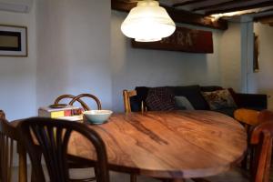 a wooden table in a living room with a couch at Casas del río in Mira +106 photos