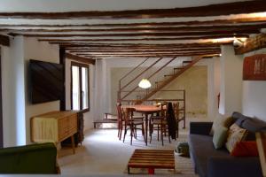 a living room with a table and chairs and a couch at Casas del río in Mira