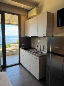 a kitchen with a refrigerator and a view of the ocean at nafsea in Afitos
