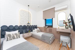 a bedroom with two beds and a mirror at Alex Hotel in Yerevan