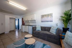 a living room with a couch and a table at St Rand Holiday House in Strand