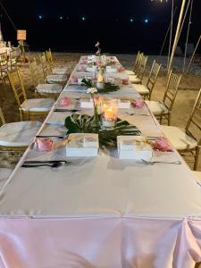 a long table with pink roses on it on the beach at Thai House Beach Resort in Lamai +45 photos