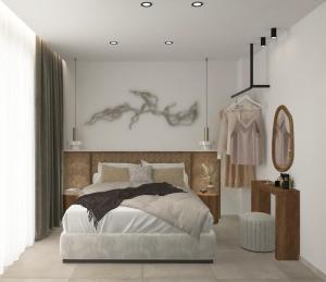 a bedroom with a large bed and a mirror at Azulic Suites Nikiti in Nikiti +53 photos