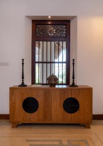 a wooden table with a window in a room at The Colonial Escape in Galle +70 photos