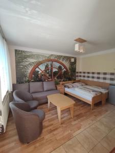 a living room with a couch and a table at Noclegi Pod Lipami in Zwierzyniec