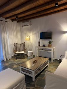 a living room with a couch and a coffee table at PANORAMIO in Batsi