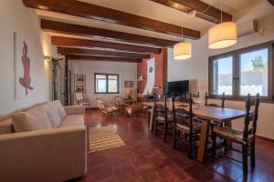 a living room with a couch and a table at Villa Isabelle on the beach in Paralía Iríon