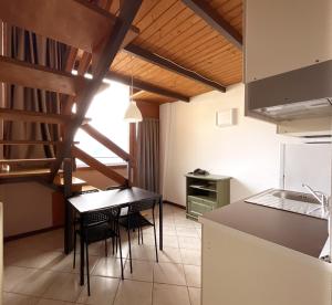 a kitchen and dining room with a table and chairs at Hotel La Rosa in Teglio