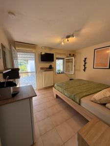 a bedroom with a bed and a television in it at The Garden Studio AVLI Upper Vrasna in Nea Vrasna