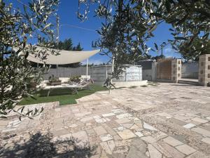 a patio with a hammock in a yard at Trullo Monticello in Martina Franca