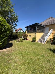 a house with a large lawn in front of it at 185 m duplex with pool near Strasbourg in Ittenheim