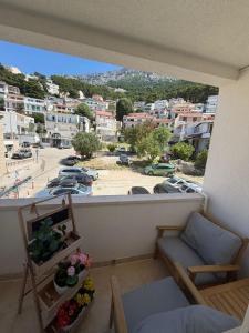 a room with a balcony with a view of a city at Apartman Vera in Brela