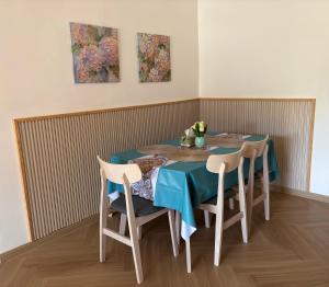 a table with four chairs and a blue table cloth at Yunis Cottage Tranquil mountain views Centrum Cameron Highlands in Brinchang