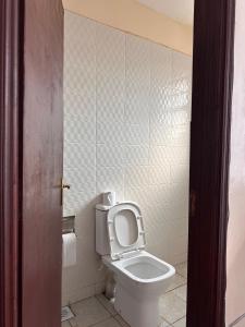 a bathroom with a toilet with the seat up at Cool Studios, Machakos in Machakos