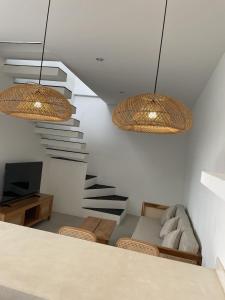 a living room with a staircase and two lights at Villa Rosa Dreams 2 in Ungasan