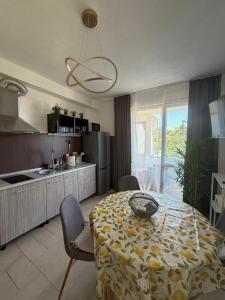 a kitchen with a table and a dining room at Apartman Vera in Brela