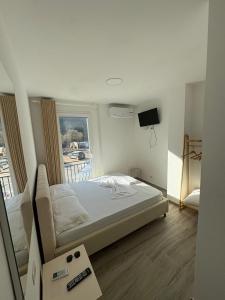a bedroom with a bed and a tv in it at Hotel SKURA , Librazhd in Librazhd
