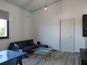 a living room with a couch and a table at L' Aurora Marina in SantʼAnna Arresi