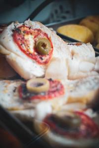 a close up of a plate of food with olives at Pousada vila bela in Porto De Galinhas