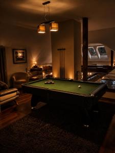 a living room with a pool table in it at Argentum Private Residence Basen Sauna Jacuzzi in Koszelówka