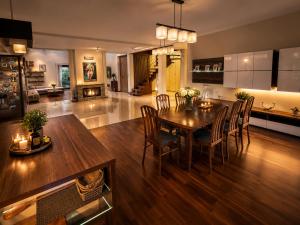 a kitchen and dining room with a table and chairs at Argentum Private Residence Basen Sauna Jacuzzi in Koszelówka