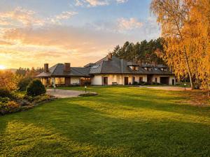 a large house with a lawn in front of it at Argentum Private Residence Basen Sauna Jacuzzi in Koszelówka