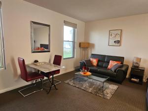 a living room with a couch and a table at Robe Marina Accommodation in Robe