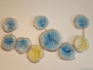 a group of glass umbrellas hanging on a wall at Robe Marina Accommodation in Robe
