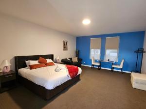 a bedroom with a bed and a table and chairs at Robe Marina Accommodation in Robe