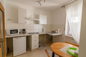 a small kitchen with a table and a microwave at B10 Rooms in Baden-Baden
