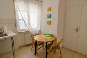 a small kitchen with a table and chairs and a window at B10 Rooms in Baden-Baden +12 photos