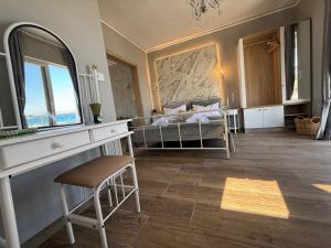 a living room with a bed and a mirror at Beachfront Luxury Studio with Panoramic Sea View in Ialysos