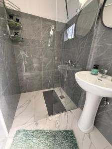 a bathroom with a sink and a shower at Beachfront Luxury Studio with Panoramic Sea View in Ialysos