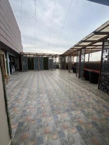an empty building with a roof with a tile floor at Hotel V Square in Lucknow