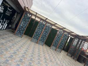 a store front with a bunch of metal doors at Hotel V Square in Lucknow