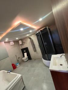 a bathroom with a shower and a toilet and a sink at Hotel V Square in Lucknow