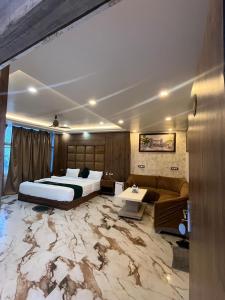 a bedroom with a bed and a large marble floor at Hotel V Square in Lucknow