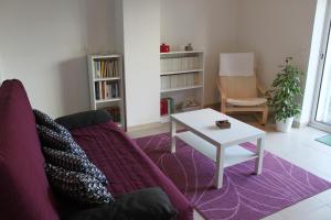 a living room with a couch and a table at Le Clos Saint Morand in Balschwiller