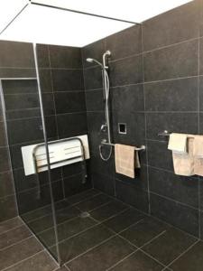 a bathroom with a shower with a glass door at Lords Hotel in Scottsdale