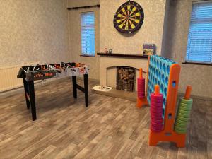 a room with a foosball table and a fireplace at Martha's Cottage in Donaghcloney