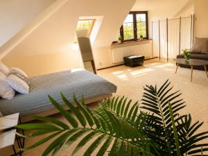 a bedroom with a bed and a plant at Argentum Private Residence Basen Sauna Jacuzzi in Koszelówka +34 photos
