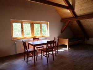 a dining room with a table and chairs and windows at Škola Kačerov in Zdobnice +18 photos