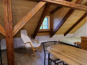 a attic room with a bed and a table at Škola Kačerov in Zdobnice