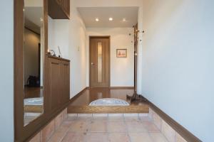 a hallway with a door and a mirror at umiakari in Naruto +16 photos