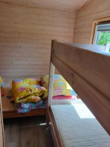 a room with two bunk beds in a cabin at Pod starą chatą 2 in Wicie